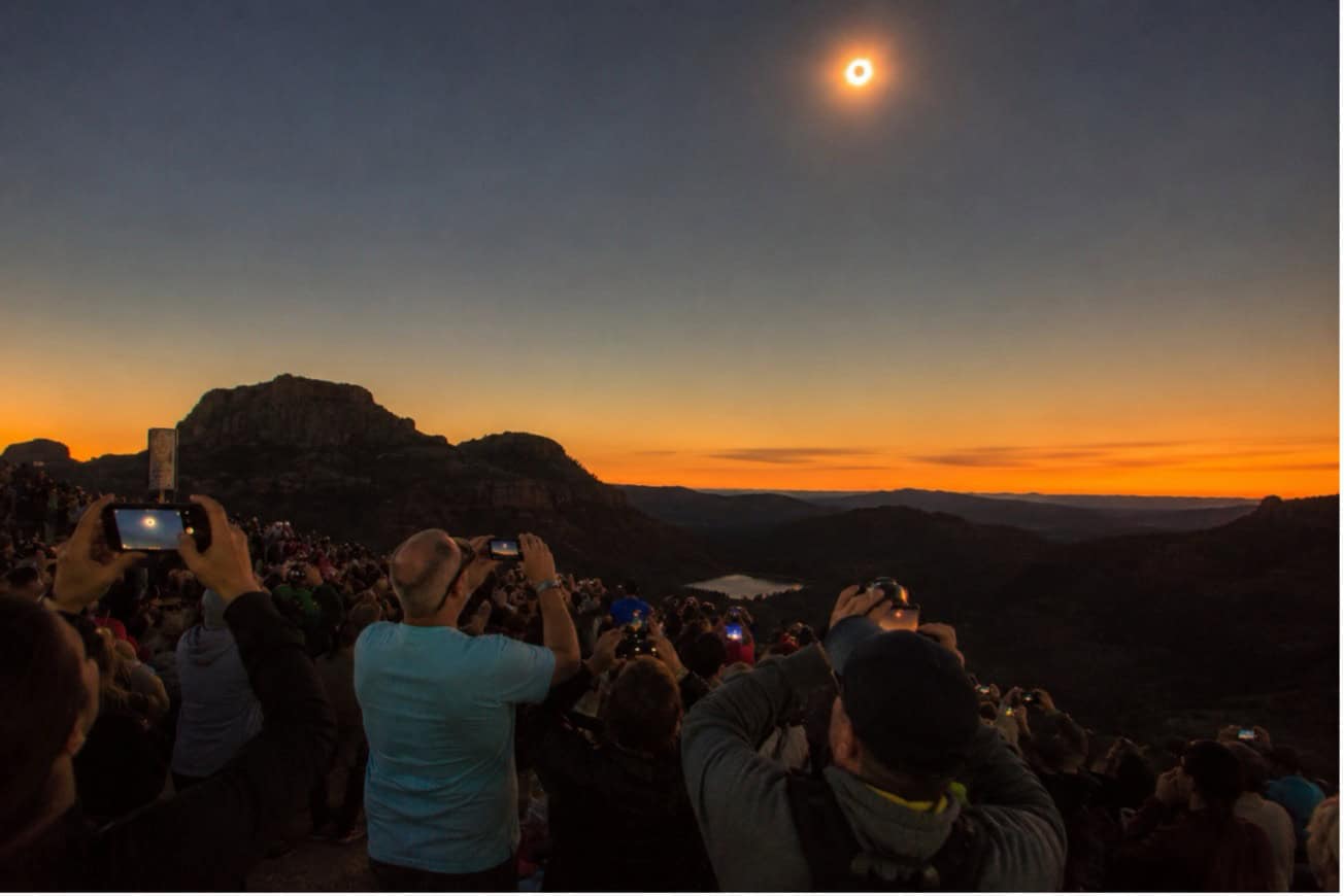 People photographing the total solar eclipse in Spain at sunset